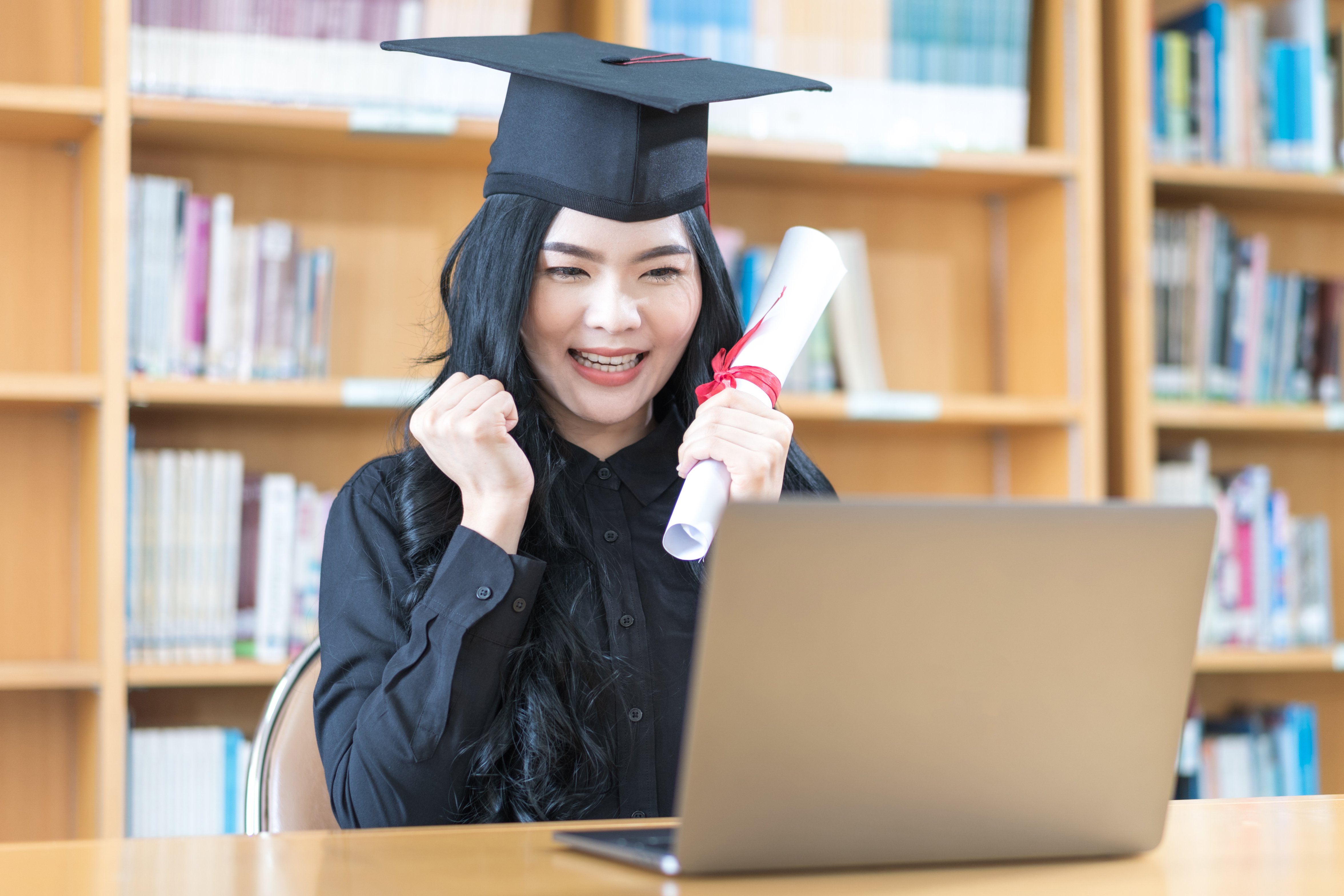 asian-university-woman-graduate-celebrates-with-family-through-video-call-virtual-convocation