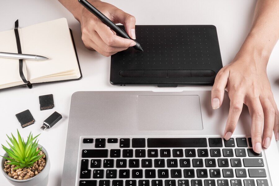 photographer-designer-using-laptop-tablet-edit_77593-249
