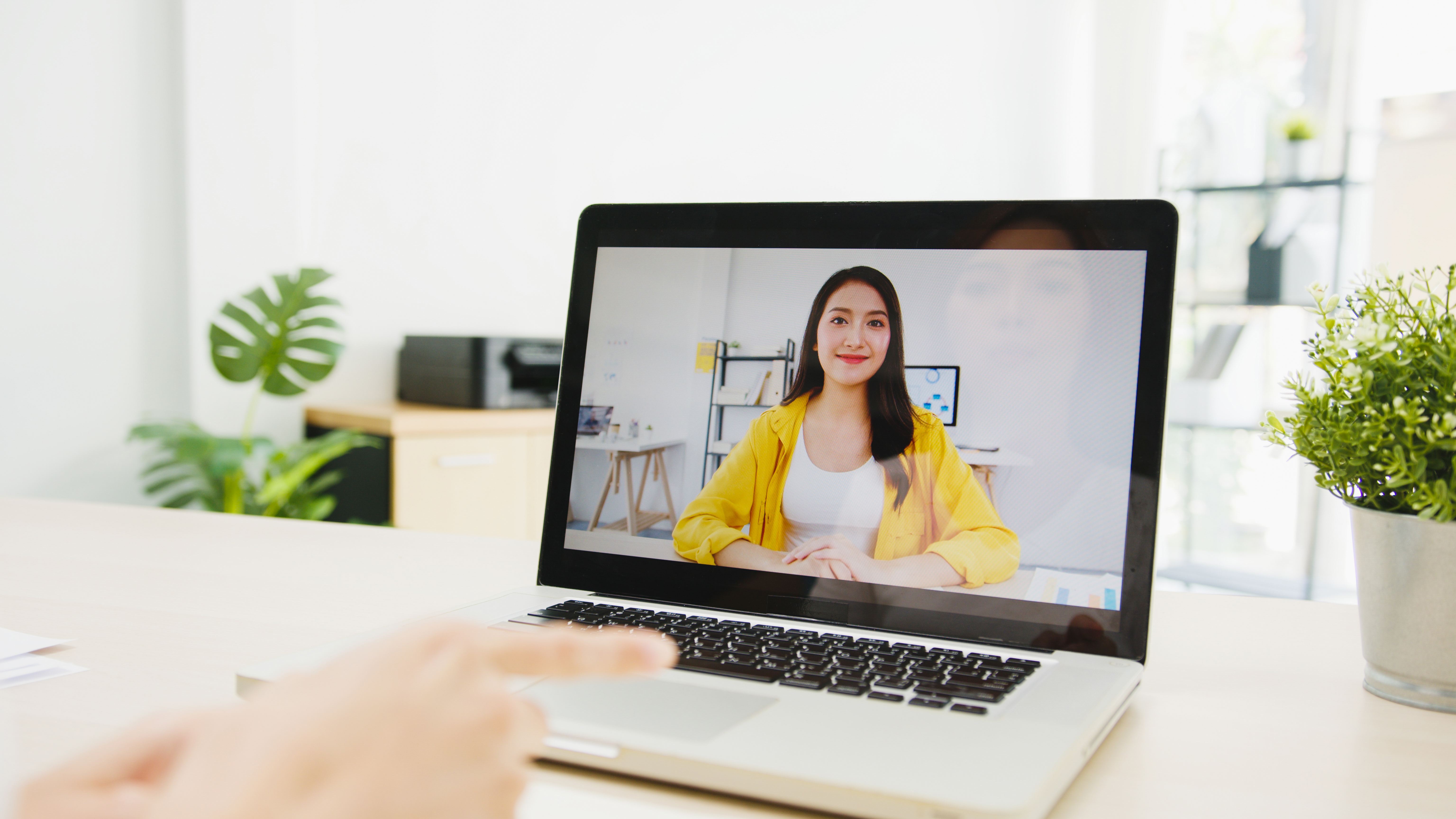 businesswoman-using-laptop-talk-colleagues-about-plan-video-call-meeting-while-working-from-home-living-room